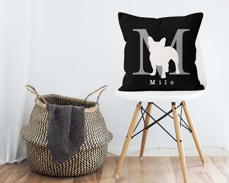 May include: Black and white throw pillow with a white silhouette of a French bulldog inside a gray letter M. The pillow has the name "Milo" printed in white below the letter.