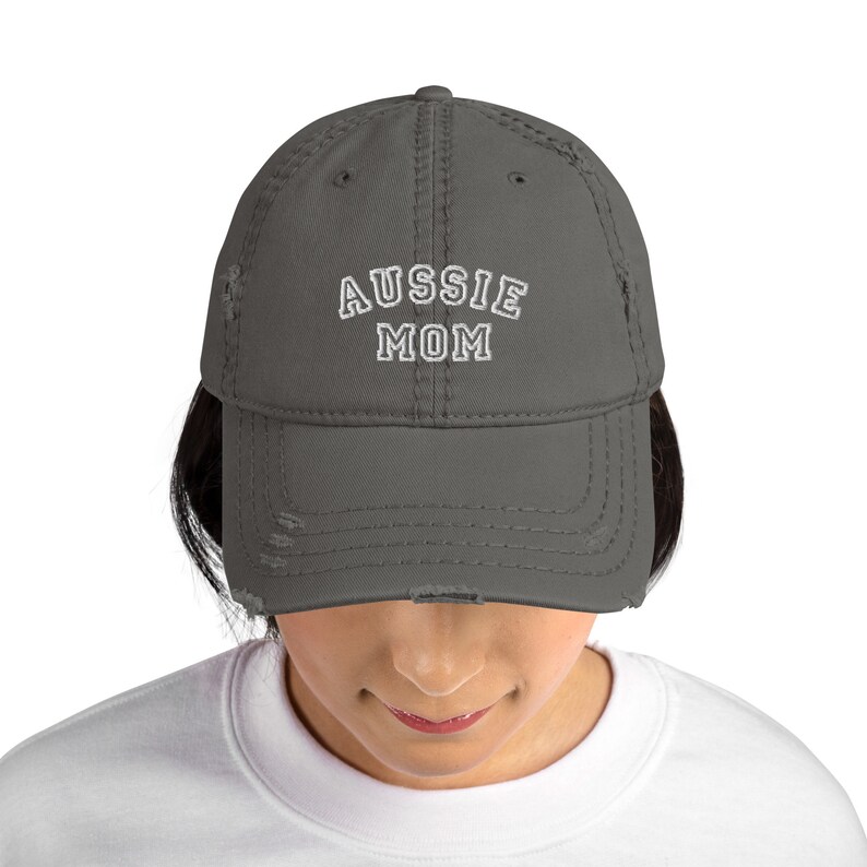 May include: A charcoal gray distressed baseball cap with white embroidered text that reads "Aussie Mom".