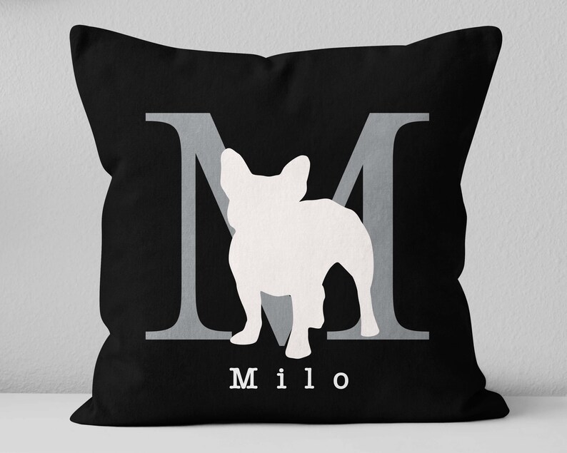 May include: Black pillow with a white silhouette of a French Bulldog and the letter "M" in gray. The name "Milo" is printed in white below the dog.