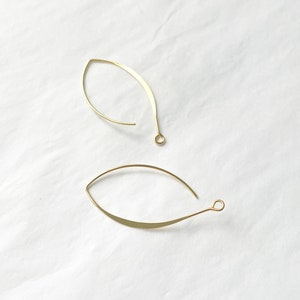 May include: Two gold leaf-shaped earring hoops with a small loop at the end of each hoop.