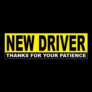 May include: Yellow sign with black text that reads "NEW DRIVER THANKS FOR YOUR PATIENCE".