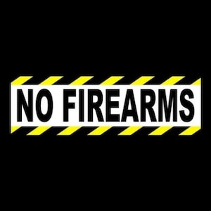May include: A rectangular sign with the words "NO FIREARMS" in bold white letters. The sign has a black background with yellow and black diagonal stripes at the top and bottom.