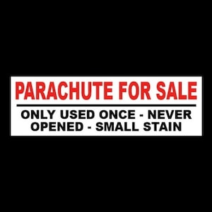 May include: White sign with black text that reads "PARACHUTE FOR SALE" and "ONLY USED ONCE - NEVER OPENED - SMALL STAIN".