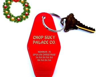May include: Red motel key chain with gold lettering that reads "Chop Suey Palace Co." and "Hohman. In Open on Christmas! Fa Ra Ra Ra Ra Ra Ra Ra Ra".