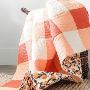 Orange buffalo check quilt kit with pattern fabric for the top and binding. Available in 5 different sizes. PreCut Kit option available.