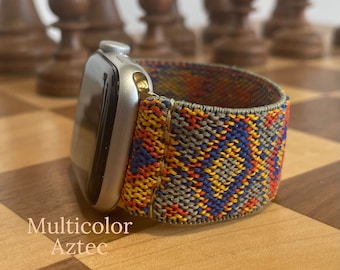 May include: A multicolor woven Apple Watch band with an Aztec pattern. The band is made of a soft, stretchy material and is compatible with Apple Watch Series 4 and later.