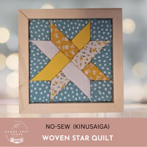 May include: A square wooden frame containing a no-sew Kinusaiga fabric art piece featuring a star pattern. The design uses teal fabric with white dots, solid yellow fabric, and white fabric with a small yellow floral print in a geometric layout.