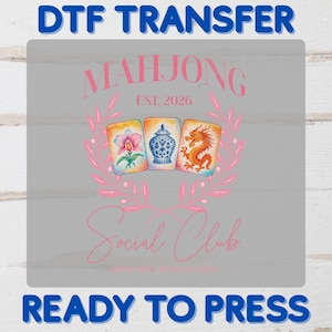 May include: DTF TRANSFER design featuring the text "MAHJONG EST. 2026" and "Social Club" in pink script. The design includes three illustrated Mahjong tiles with floral and dragon motifs, surrounded by a pink floral wreath. The words "READY TO PRESS" are at the bottom.