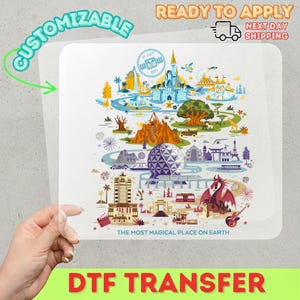 May include: A DTF transfer with a vibrant theme park map illustration, showcasing a castle, a large sphere, and a dragon. The text "CUSTOMIZABLE" and "READY TO APPLY" are present. The phrase "THE MOST MAGICAL PLACE ON EARTH" is also included.