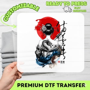 May include: A white DTF transfer featuring a geisha with a dragon tattoo, holding a katana in front of a red sun. The design includes Japanese calligraphy and the words "CUSTOMIZABLE" and "READY TO PRESS".