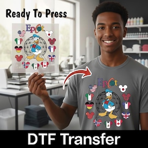 May include: A gray t-shirt and a DTF transfer featuring Donald Duck in front of a geodesic sphere with the word "Epcot". The design includes flags and Mickey Mouse heads. The words "Ready To Press" and "DTF Transfer" are also visible.