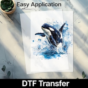 May include: DTF transfer sheet with a watercolour illustration of a killer whale leaping from the water. The orca is in black and white, with blue water splashes. Text at the top reads "Easy Application" and at the bottom "DTF Transfer".