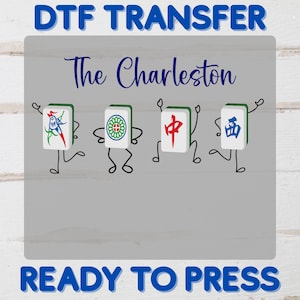 May include: DTF Transfer design with the text "The Charleston" above four animated Mahjong tiles. The tiles are white with green borders and various symbols. The text "READY TO PRESS" is below. The design is on a grey background.