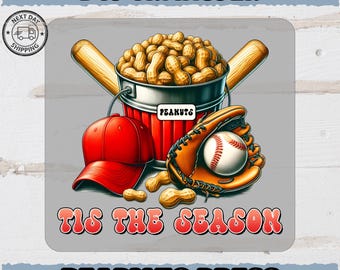 May include: DTF transfer design featuring baseball elements. A red baseball cap, a baseball glove with a baseball, and a bucket of peanuts are displayed. The text "TIS THE SEASON" and "READY TO PRESS" are also included.