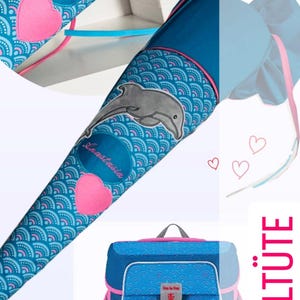 May include: A blue and pink school backpack with a dolphin design and the text "Step by Step". The backpack is next to a blue and pink school cone with a dolphin design and the text "Anastasia". The image has the hashtag "#Schultute" in the corner.