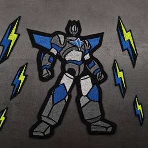 May include: A grey, blue and white robot with a star on its chest, standing with its legs spread apart. The robot is surrounded by five yellow lightning bolts.