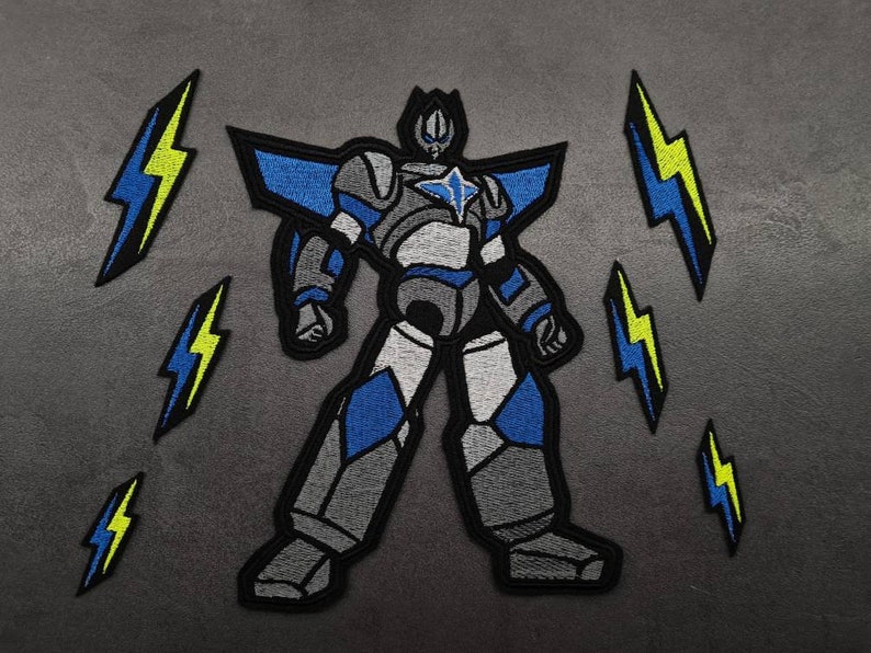 May include: A grey, blue and white robot with a star on its chest, standing with its legs spread apart. The robot is surrounded by five yellow lightning bolts.