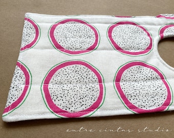 May include: White fabric with a pink and green dragon fruit pattern. The fabric is quilted and has a hole in the top right corner.