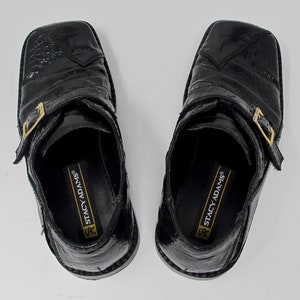 May include: A pair of black leather shoes with a buckle strap and the text "Stacy Adams" on the inside.