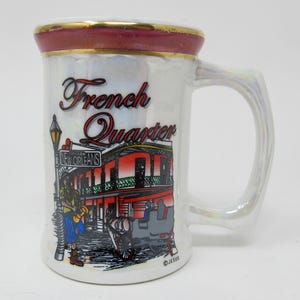 May include: A set of three ceramic mugs with a speckled, matte finish. The mugs are in shades of cream, light gray, and dark gray. Each mug has a simple, minimalist design, perfect for coffee or tea.