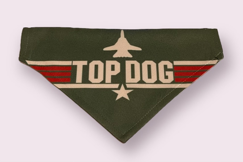 May include: Green dog bandana with a white star, red stripes, and the text "TOP DOG" in white. A silhouette of a fighter jet is above the text.