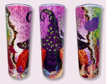 May include: Three stainless steel tumblers with a Halloween theme. Each tumbler features a black cat wearing a witch's hat with stars and a crescent moon. The cat is surrounded by pumpkins, mushrooms, and other Halloween imagery. The tumblers are decorated with a pink, purple, and green color scheme.