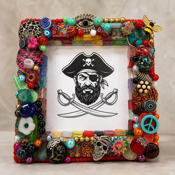 A maximalist mixed-media beaded picture frame that looks like wearable art exploded onto your shelf — genuinely one-of-a-kind and conversation-starting.
