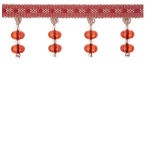May include: Decorative trim with a red and beige woven band, patterned with dots. Hanging from the band are orange, oval beads, each with a small, clear bead at the bottom. Suitable for craft and design projects, this trim adds a decorative touch.