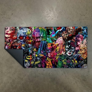Könnte beinhalten: Ein rechteckiger, farbenfroher Teppich mit einer Collage von Popkultur-Charakteren, darunter Batman und Catwoman. Das Design ist im Comic-Stil gehalten und hat eine dunkelgraue Rückseite. Geeignet für verschiedene Zwecke.
