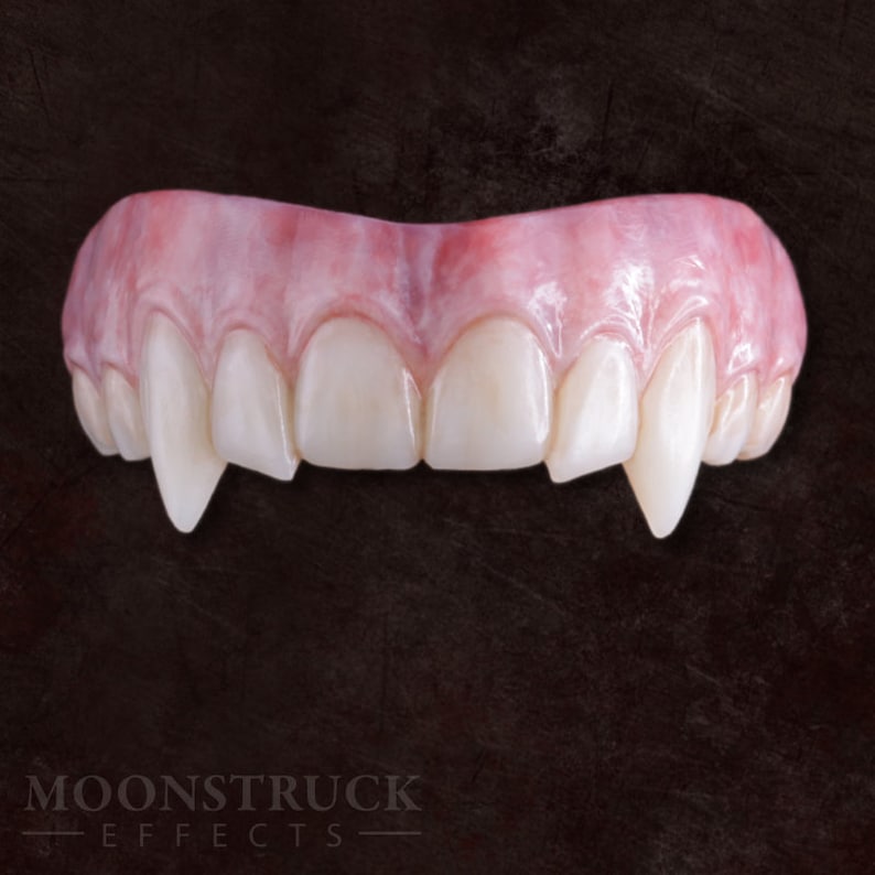 May include: A set of realistic-looking vampire fangs, made of a flexible, pink material. The fangs are designed to fit over the wearer's teeth and create a scary, vampire-like appearance.