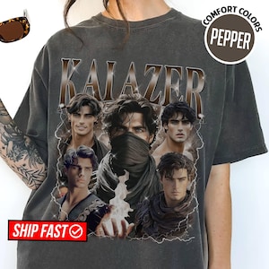 May include: Dark gray t-shirt with the word "KALAZER" in a brown, textured font. The shirt features a collage of male figures with dark hair and various outfits. The words "COMFORT COLORS" and "PEPPER" are in a circular design.