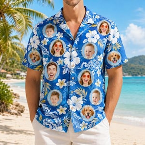 May include: A short-sleeve button-down shirt in blue featuring a white hibiscus floral pattern and circular photo frames containing portraits of children and golden retriever dogs arranged across the front of the garment.