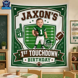 May include: A green and white fabric banner featuring a football theme with the text JAXON'S 1ST TOUCHDOWN BIRTHDAY. The design includes a football field graphic, a football, a helmet, and a foam finger icon with the number 1.