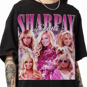 May include: Black t-shirt with a pink graphic print of four women and a dog. The text "Sharpay Evans" is printed in pink on the shirt.