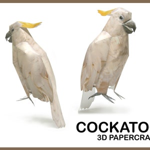 May include: A white cockatoo papercraft model with a yellow crest. The model is posed in two different positions, one with its head turned to the side and the other with its head facing forward. The text "COCKATOO 3D PAPERCRAFT" is printed below the models.