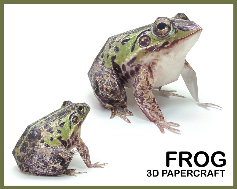May include: Two papercraft frogs, one large and one small, are shown against a white background. The frogs are green and brown with black spots. The larger frog is sitting up with its legs outstretched. The smaller frog is sitting with its legs tucked under its body. The text "FROG 3D PAPERCRAFT" is printed below the frogs.