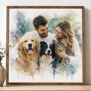 May include: A square framed wall art piece featuring a watercolor-style portrait of two people, a golden retriever, a black and white border collie, and a tabby cat. The subjects are depicted against a soft, blended background of blue, green, and tan.