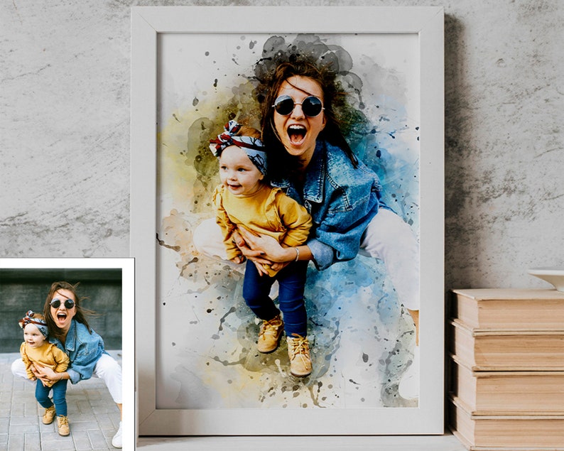 May include: Watercolor portrait of a woman and child in a white frame. The woman wears sunglasses and a denim jacket, holding the child in a yellow top and blue jeans. The artwork has a colorful, abstract background with paint splatters.