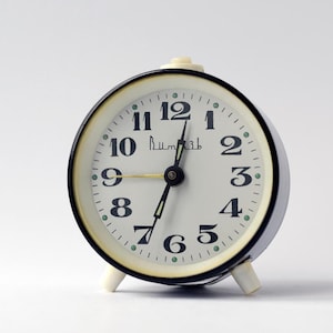 Alarm black clock Vitjaz, Vintage mechanical wind up clock from 80s. Mid century style tabletop small clock