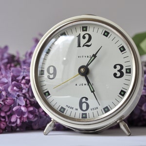 Alarm white clock Vitjaz, Vintage mechanical wind up clock made in 80s. Tabletop Mid century style small clock