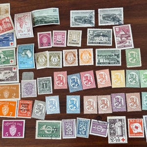 May include: A collection of vintage postage stamps, featuring various designs and colors. Stamps depict landscapes, transportation, and heraldic symbols. Some stamps have text in multiple languages, including "SUOMI" and "NORGE".
