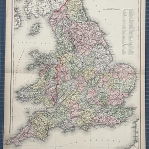 May include: An antique map of England and Wales, printed in black and white with coloured borders for each county. The map shows the major cities, towns, and rivers. The title "England and Wales" is printed at the top of the map.