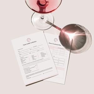 May include: Two white sheets of paper with a pink border. The top sheet has the text "Mark Smith Aesthetics" and a form with questions about skin care. The bottom sheet has the text "Botox Treatment Plan" and a grid with spaces for notes. A glass of red wine is in the background.