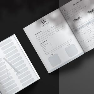May include: A white lash client record book with black text and graphics. The open pages feature sections for client information, medical history, and lash style details, including illustrations of eyelashes and blank boxes for before and after photos.