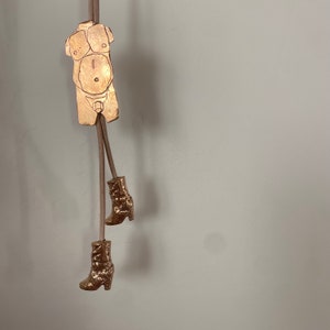 Bronze body bolo tie with high heeled boots