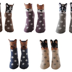 May include: Six pairs of colorful socks with a polka dot pattern and a dog face design. The socks are in brown, purple, gray, blue, and beige.