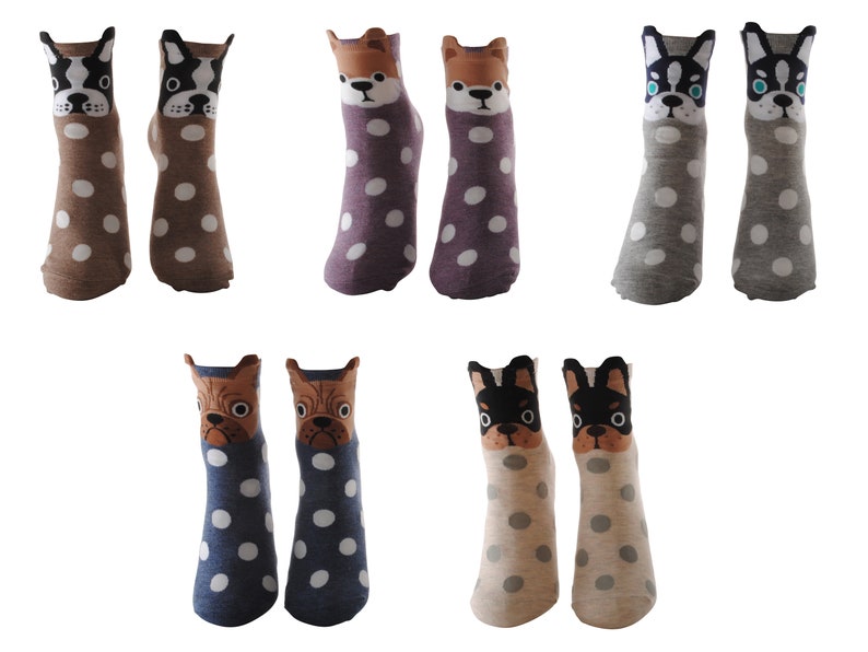 May include: Six pairs of colorful socks with a polka dot pattern and a dog face design. The socks are in brown, purple, gray, blue, and beige.