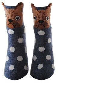 May include: A pair of blue socks with white polka dots and a brown dog face on the top of each sock.