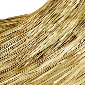 May include: Close-up of a woven texture made of natural fibers, resembling a straw or rush mat. The fibers are light brown and have a slightly rough texture.