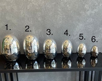 Egg shaped Fork, Knife and Spoon storage box Available in Silver and Gold. Manufactured using high quality brass material.